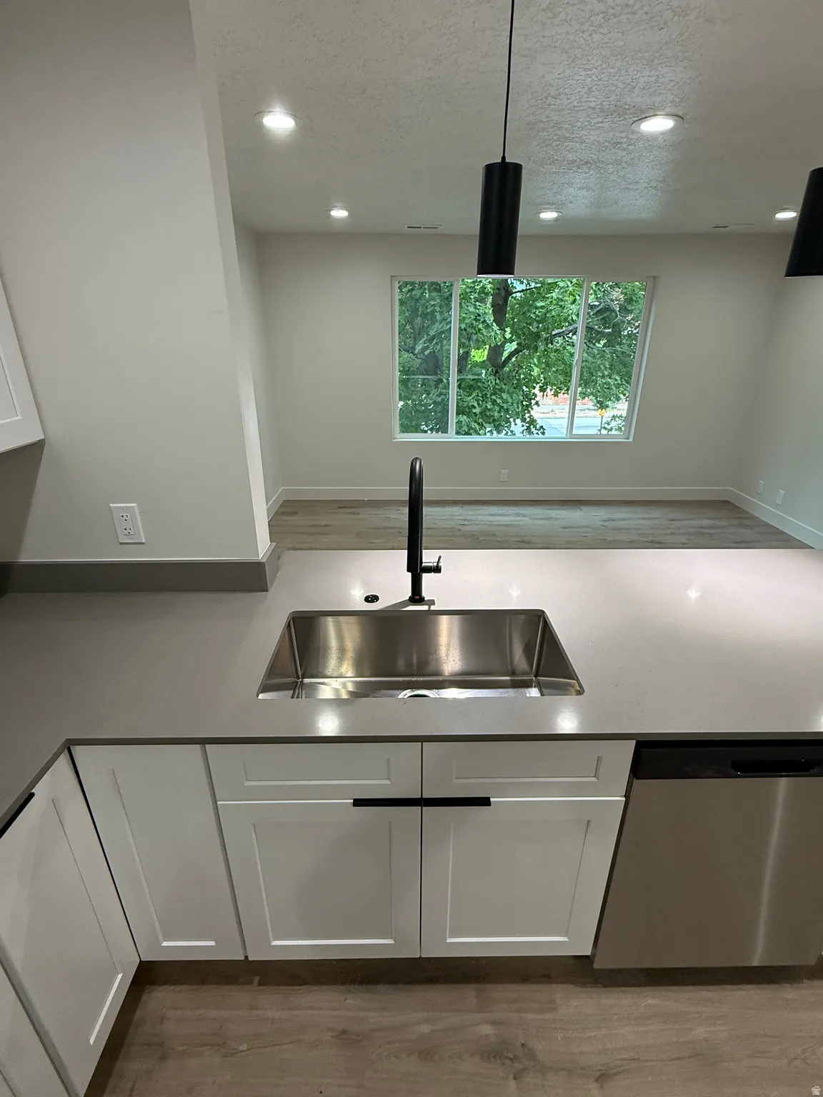Stainless steel undermount sink with a matte black faucet