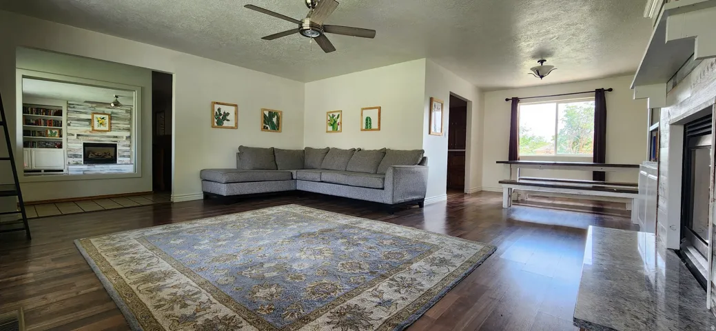 Hardwood-finish flooring throughout, complemented by recessed lighting and a ceiling fan