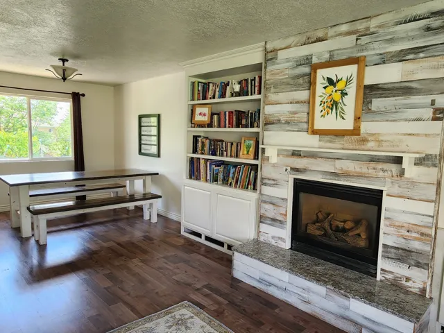 Fireplace featuring a granite hearth and a wood-finish surround