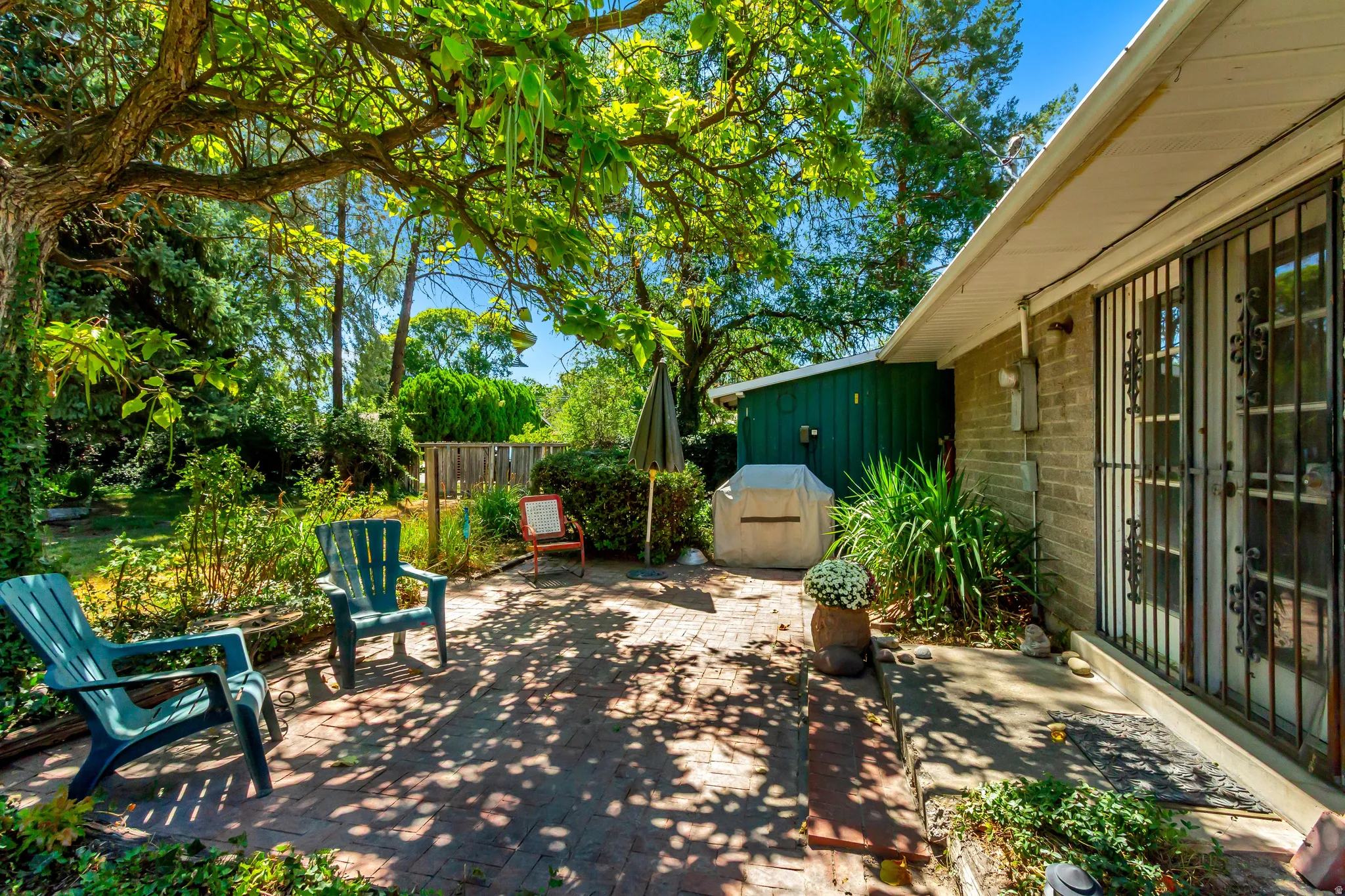 Brick paver patio with extensive mature landscaping