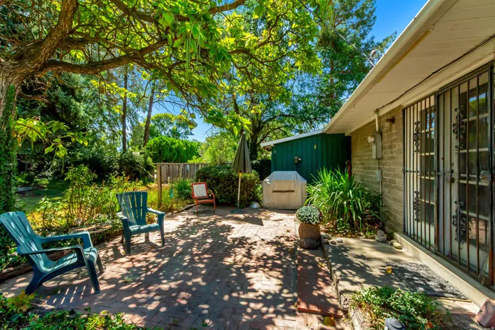 Brick paver patio with extensive mature landscaping