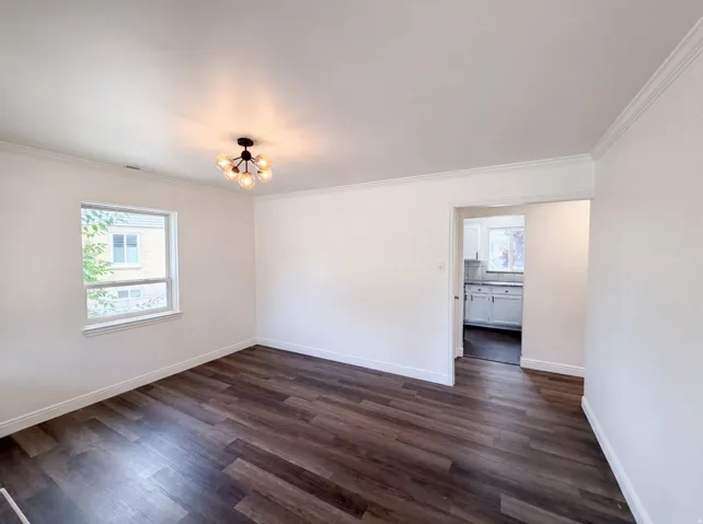 Wood-finish flooring, white walls, and a contemporary multi-globe light fixture