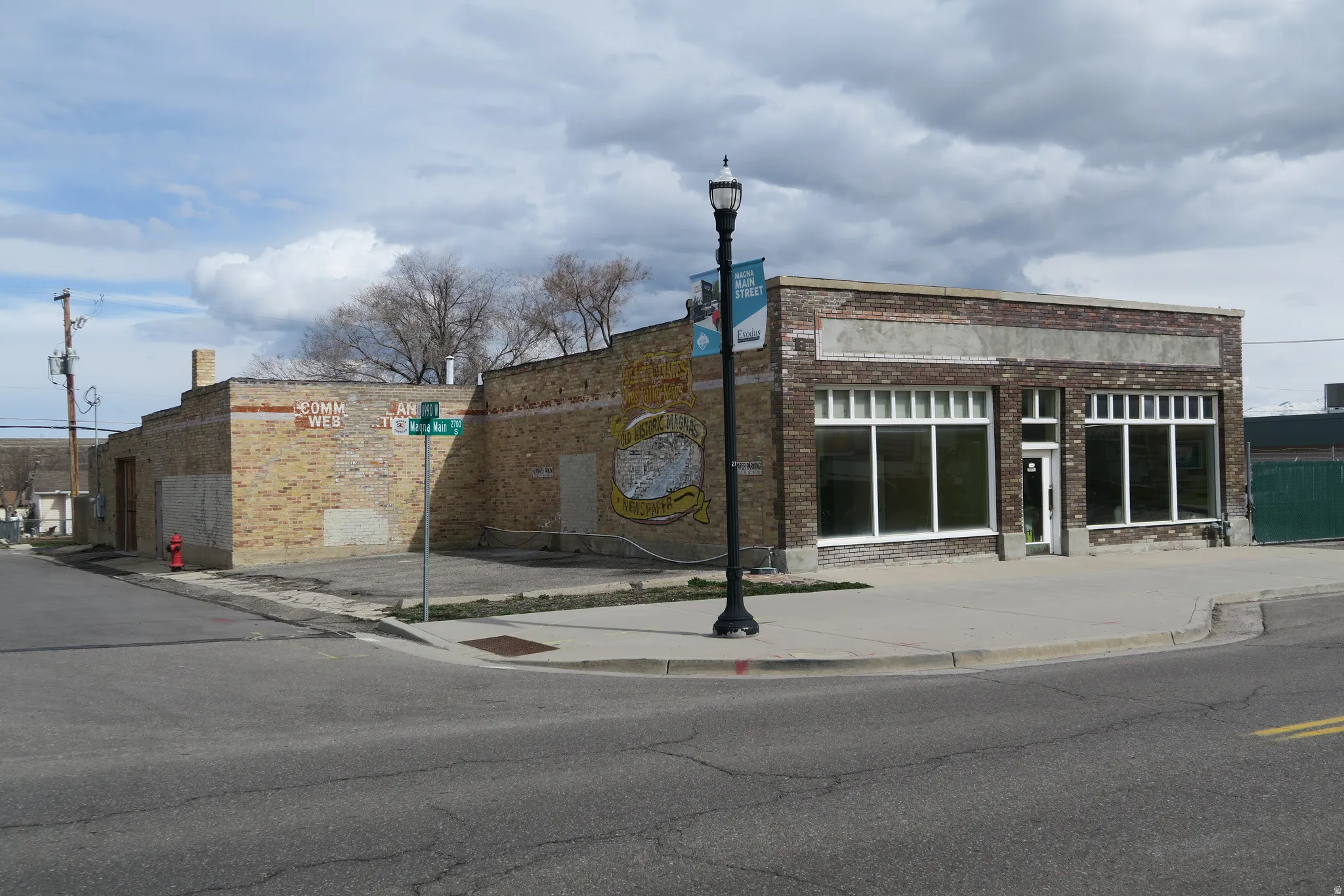 Two-story brick exterior with large storefront windows and a prominent entry