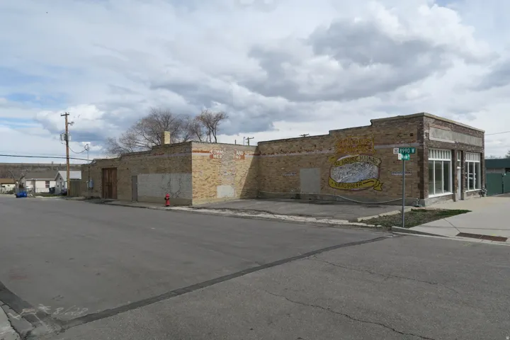 Brick exterior with street frontage, multiple window openings, and a prominent corner location