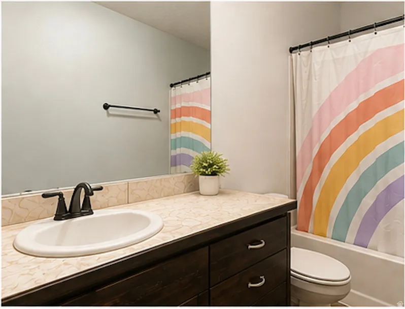 Integrated vanity with a dark wood-finish cabinet and an oval undermount sink