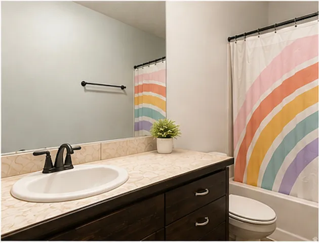 Integrated vanity with a dark wood-finish cabinet and an oval undermount sink