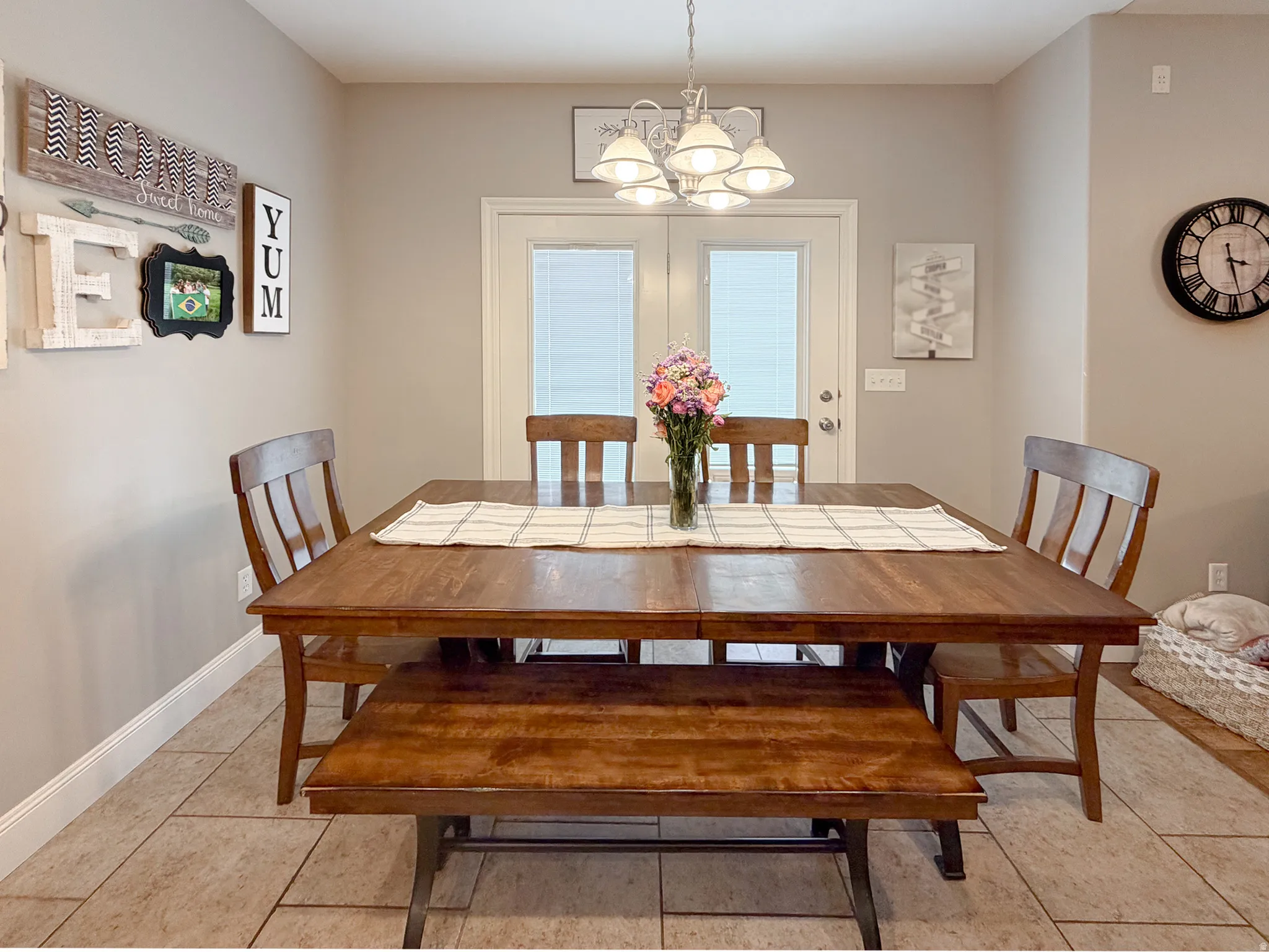 Dining area featuring neutral wall paint, tile flooring, and a multi-light ceiling fixture