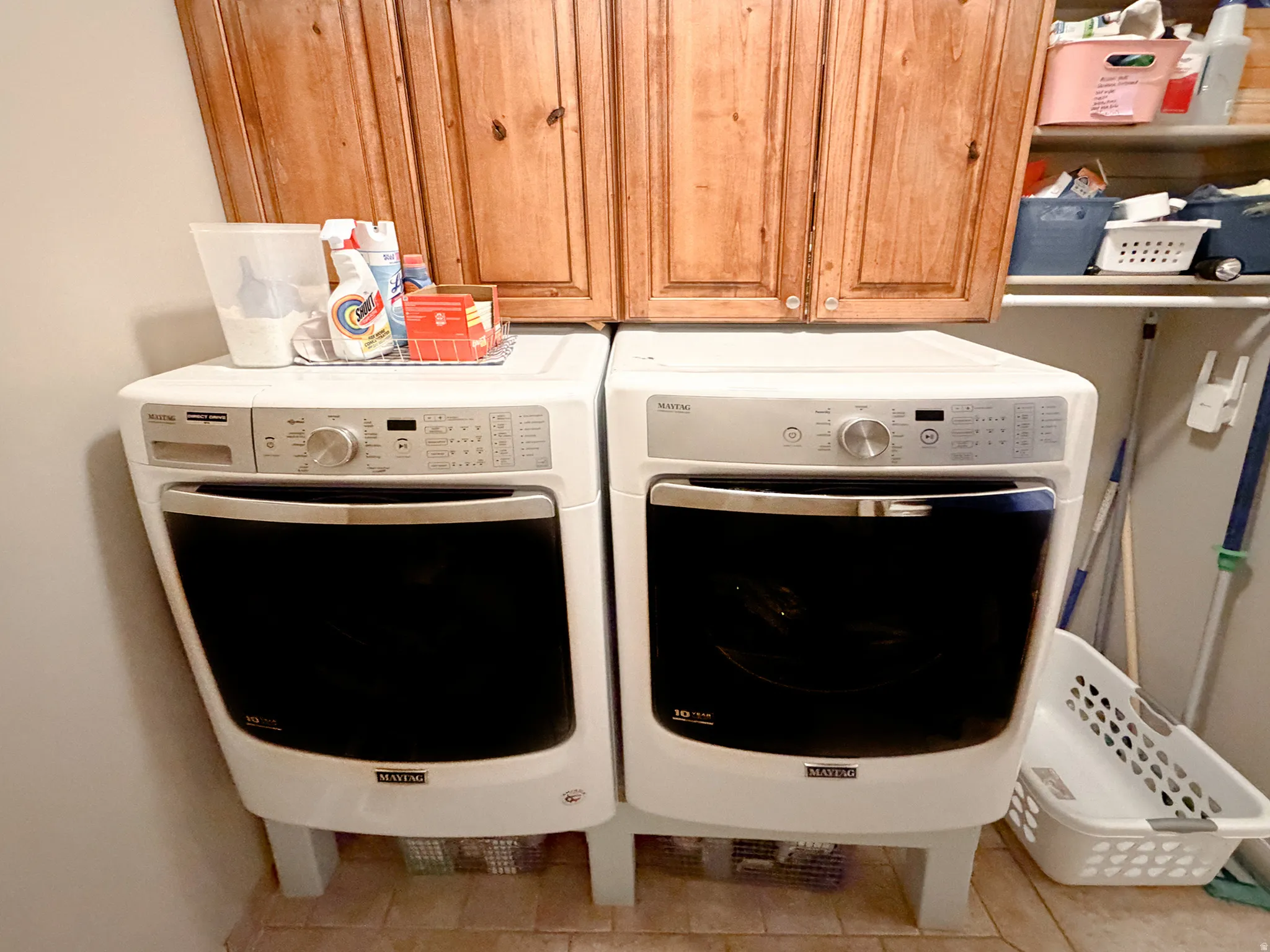 Built-in wood cabinetry, integrated shelving, and tiled flooring