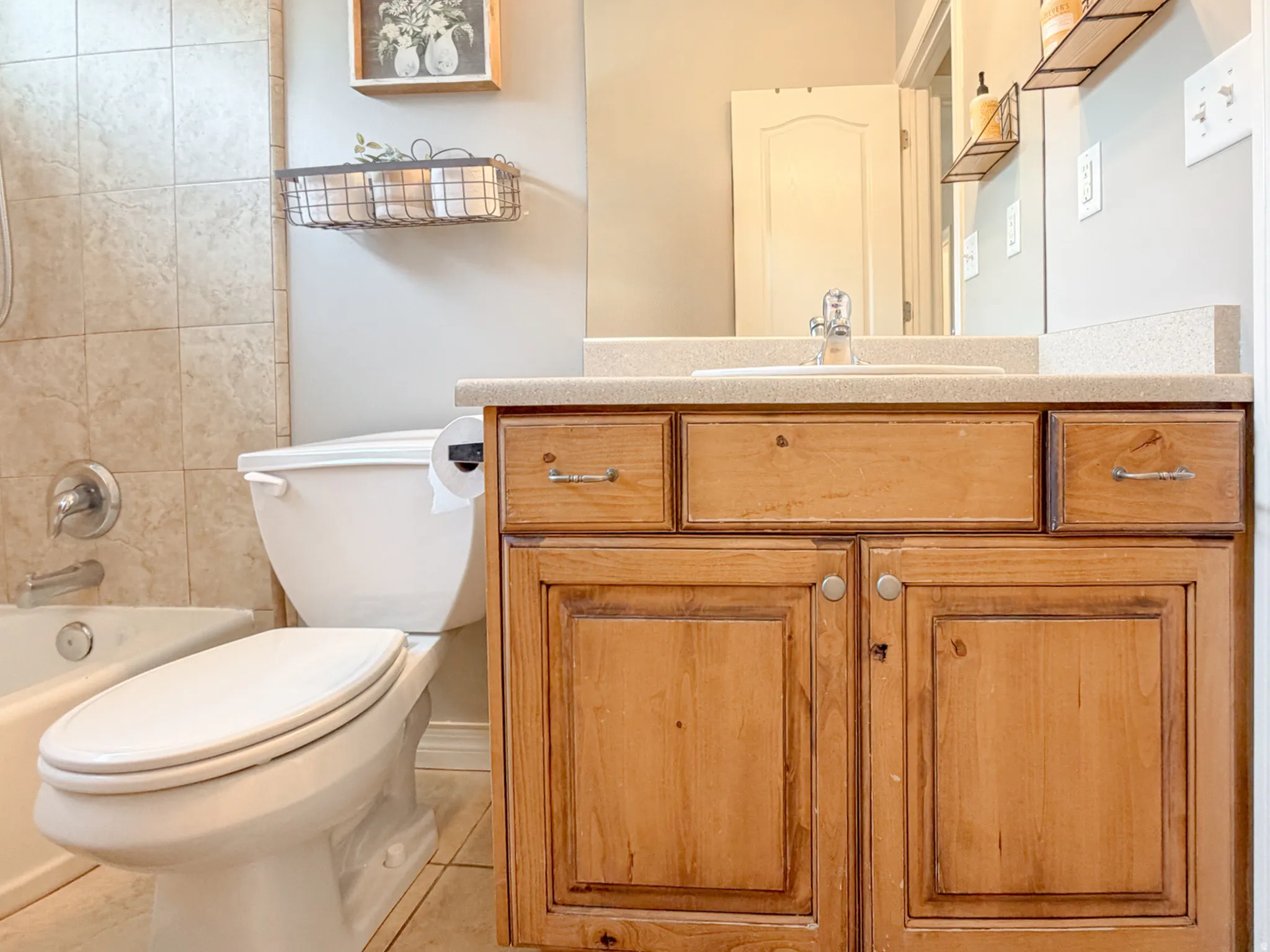 Wood-finish vanity with built-in sink and light-toned countertop