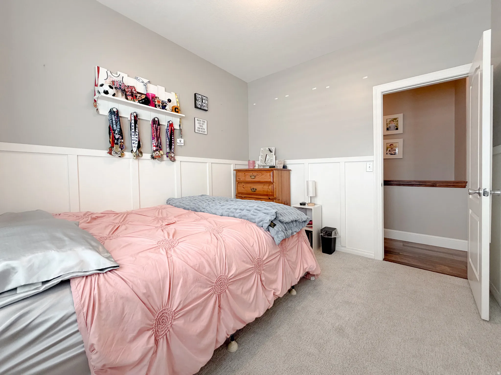 Neutral wall color with white wainscoting, recessed lighting, and carpet flooring