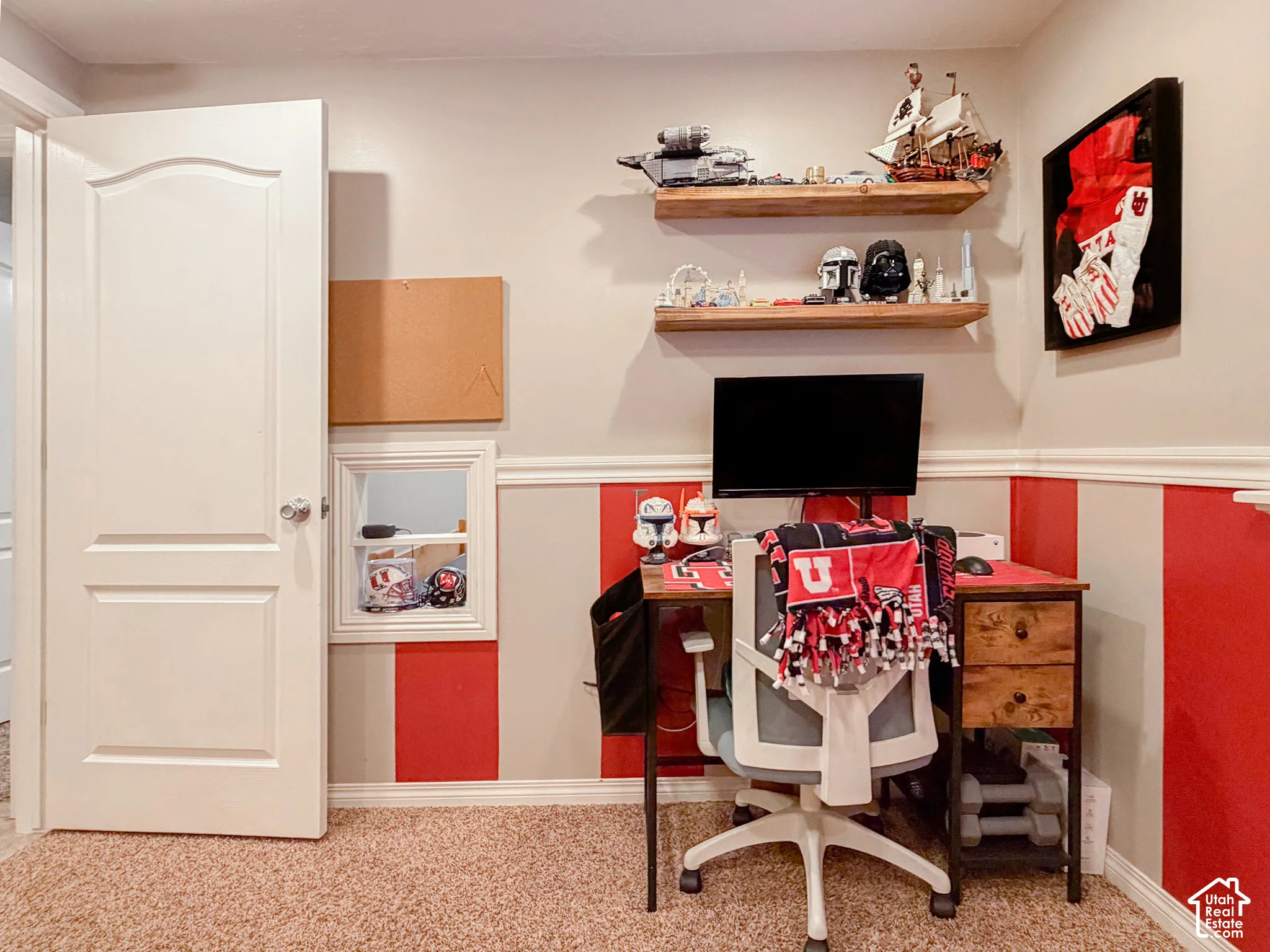 Wall-mounted wood-finish floating shelves, light-toned carpeting, and a built-in wall niche with shelving