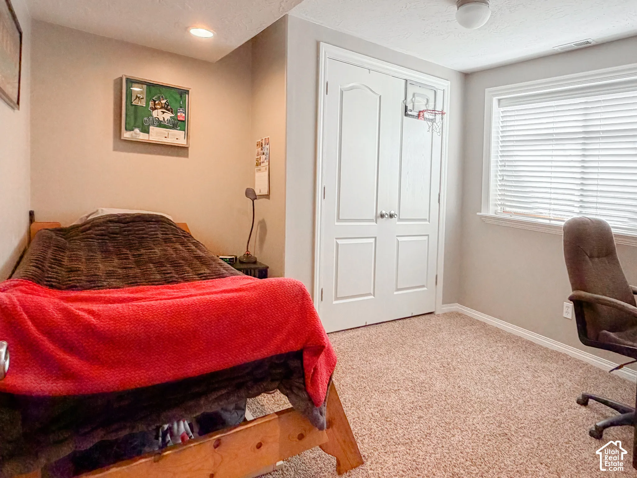 Soft neutral carpeting, white window blinds, and recessed lighting