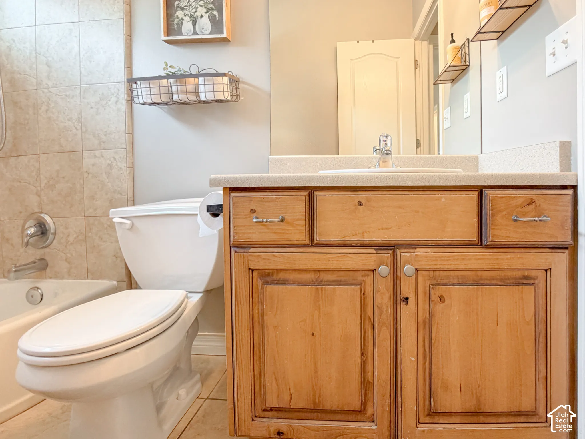 Wood-finish vanity with built-in sink and light-toned countertop