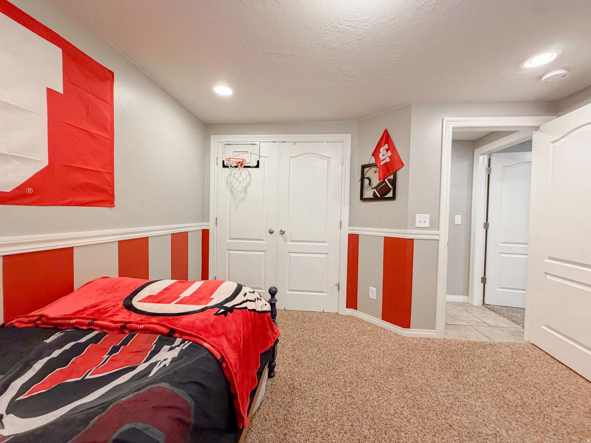 Recessed ceiling lighting, textured carpeting, panel doors, and wainscoting