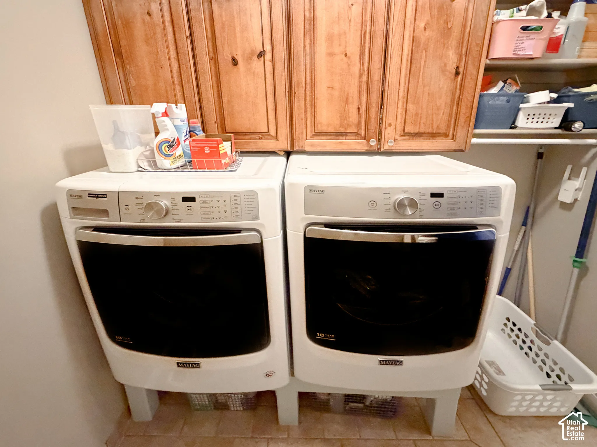 Built-in wood cabinetry, integrated shelving, and tiled flooring