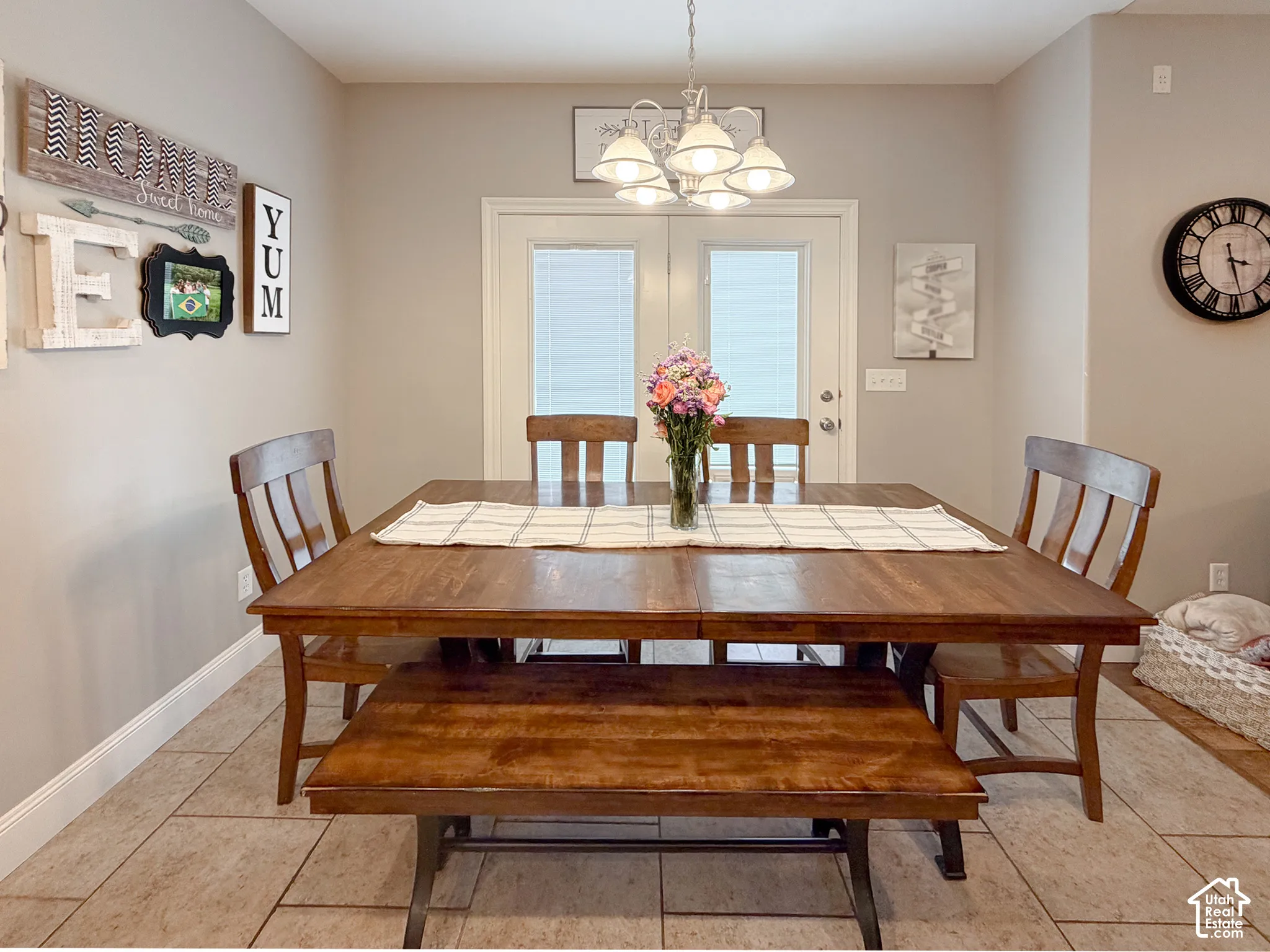 Dining area featuring neutral wall paint, tile flooring, and a multi-light ceiling fixture
