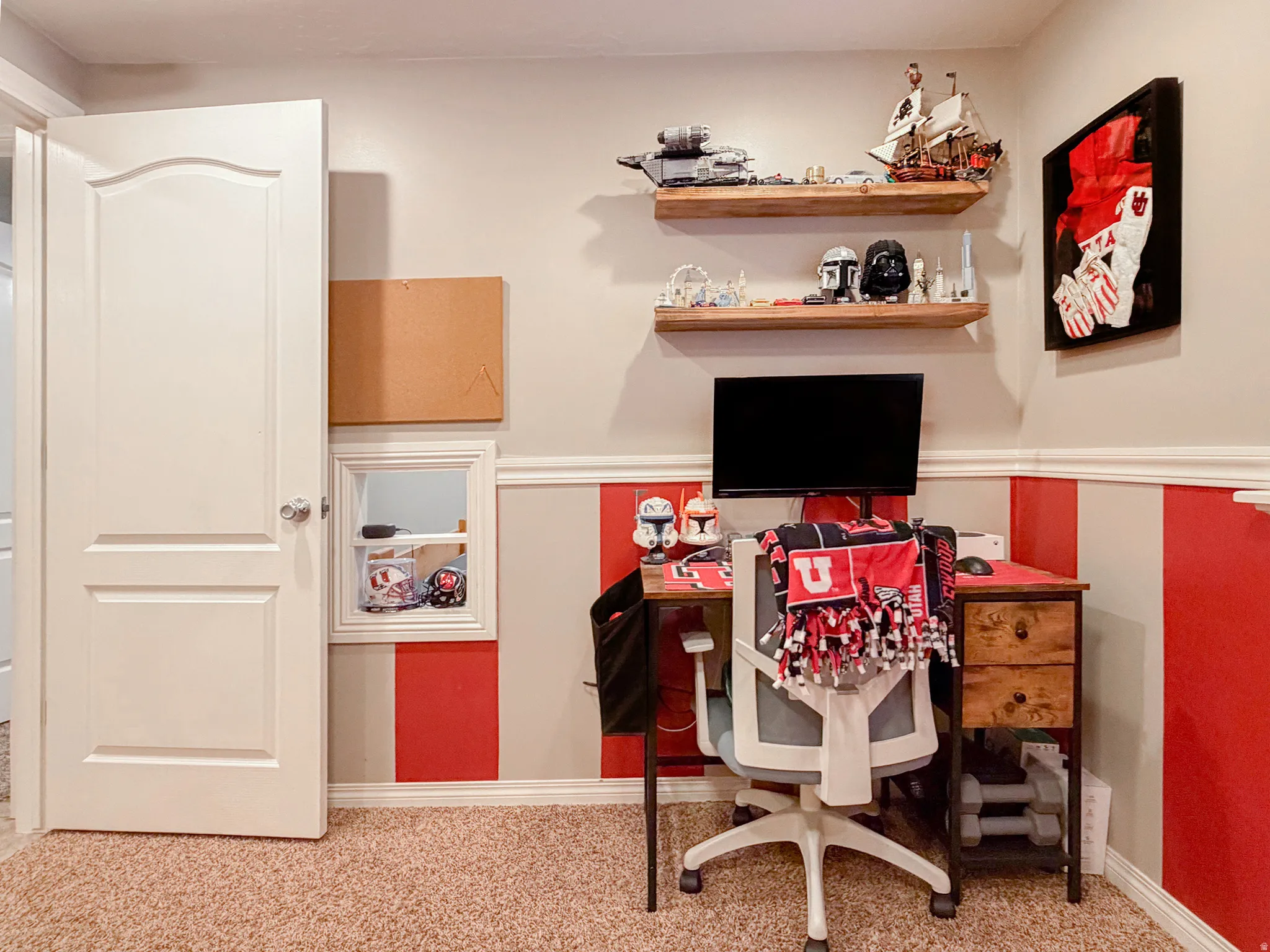 Wall-mounted wood-finish floating shelves, light-toned carpeting, and a built-in wall niche with shelving