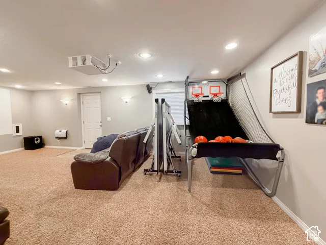 Recessed lighting throughout, ceiling-mounted projector, and carpeted flooring