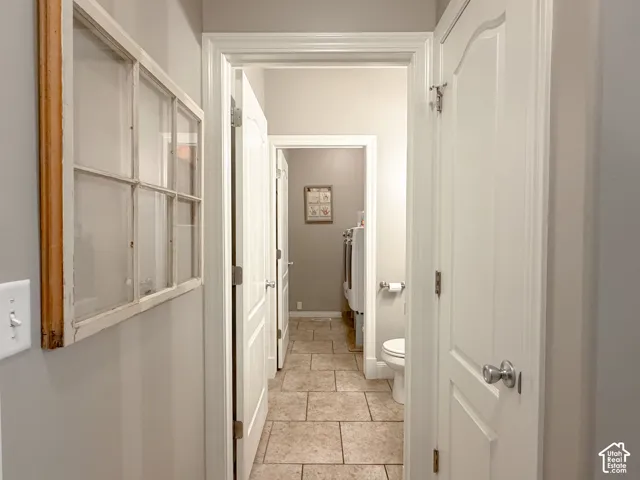 Neutral wall color, white trim, paneled interior doors, and tile flooring