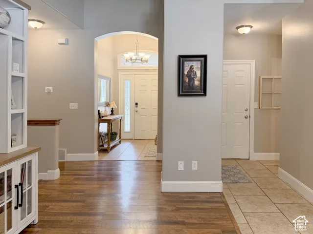 Archway entry with a decorative chandelier