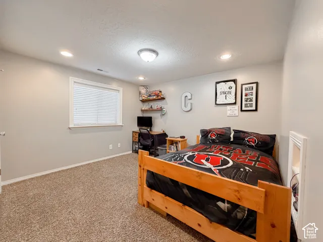 Carpeted room with recessed lighting and a flush mount ceiling fixture