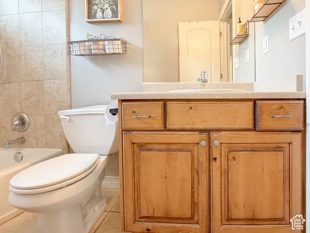 Wood-finish vanity with built-in sink and light-toned countertop