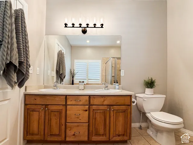 Dual vanity with wood-finish cabinetry, integrated sinks, and a single-piece mirror
