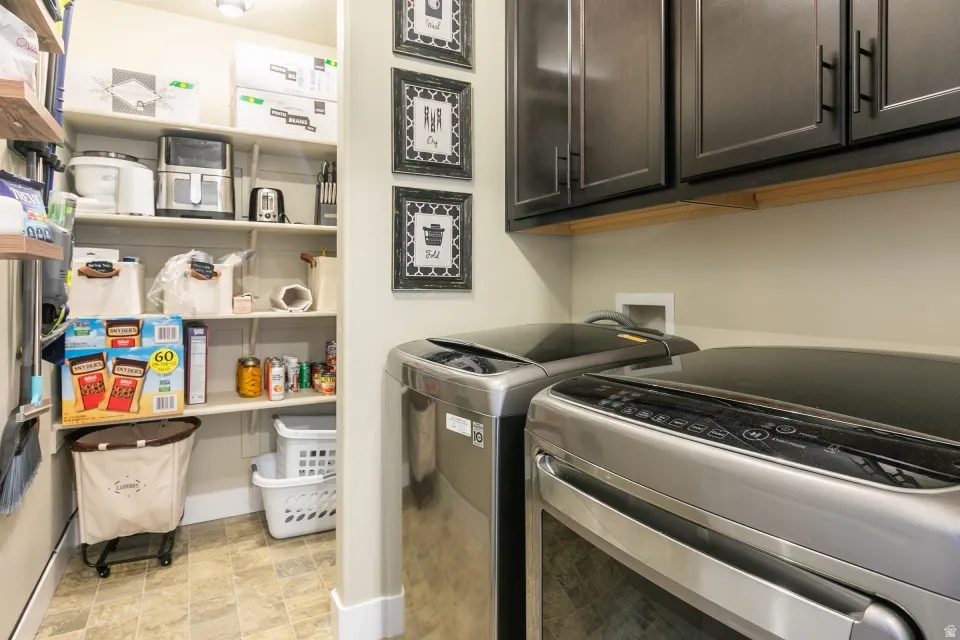 Laundry area with dark wood-finish cabinetry, light wall paint, and tiled flooring