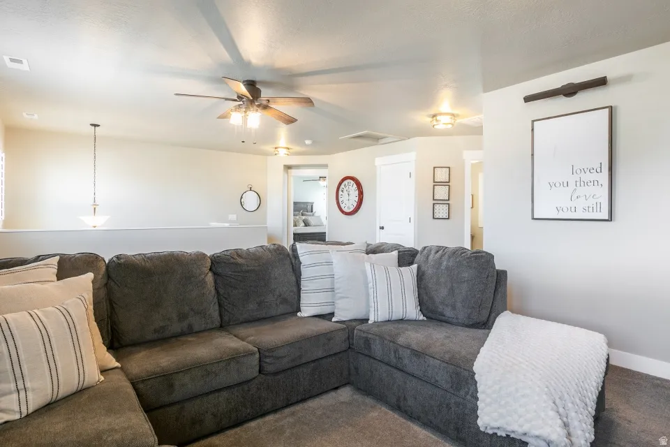 Recessed lighting, ceiling fan, pendant light fixture, carpeted flooring, and white interior doors