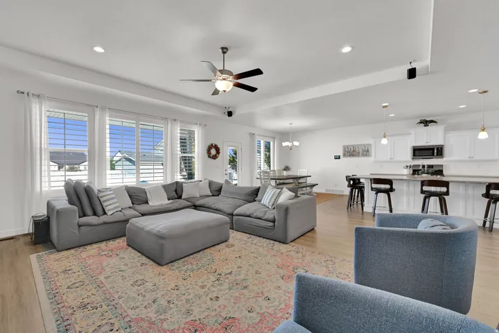 Open-concept living space with light wood-finish flooring