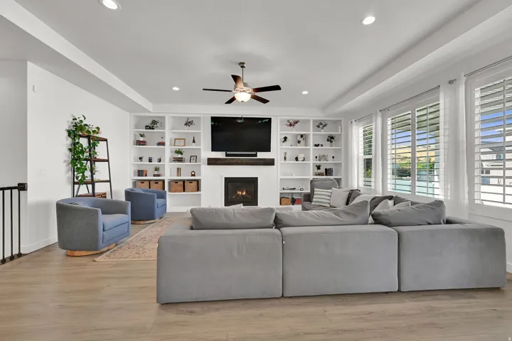 Wood-finish flooring, recessed lighting, and a ceiling fan