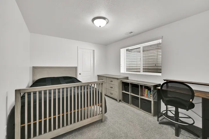 Recessed lighting, white walls, and a window with blinds