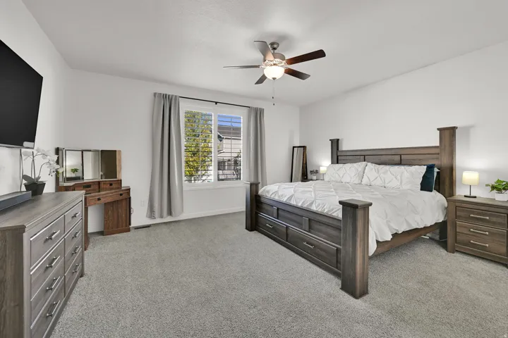 Recessed lighting, ceiling fan with integrated light, window with blinds, and light gray carpeting