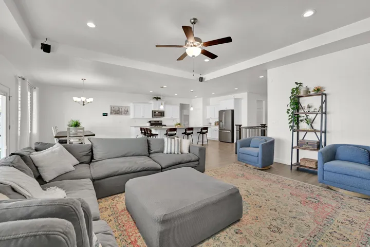 Open concept living area featuring wood-finish flooring, recessed lighting, and a ceiling fan