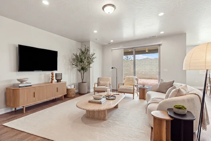 Recessed lighting illuminating a spacious living area with wood-finish flooring