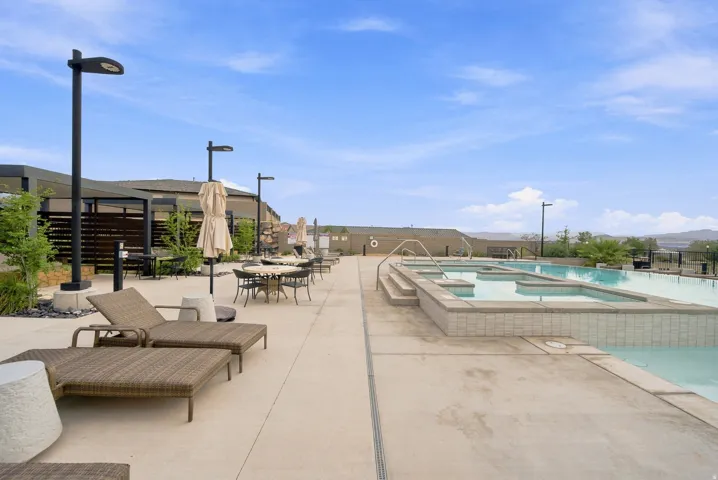 Expansive concrete deck with a multi-level pool and integrated spas
