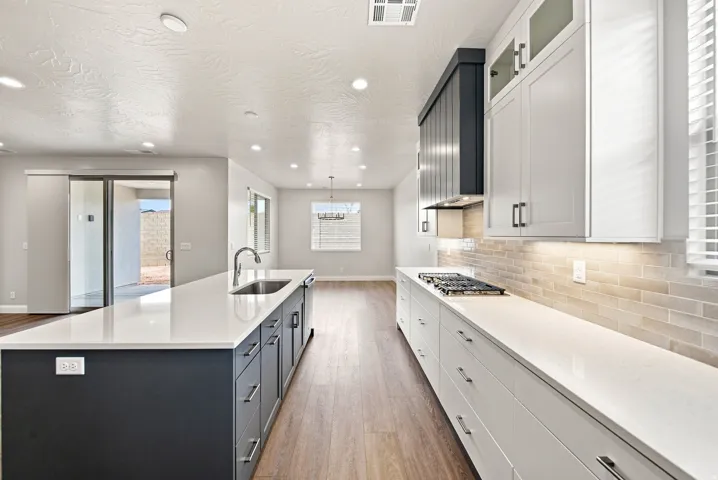 Kitchen featuring a gas cooktop, under-cabinet lighting, and a subway tile backsplash