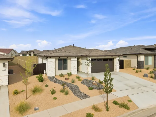 Contemporary exterior featuring a neutral stucco facade and stone accents