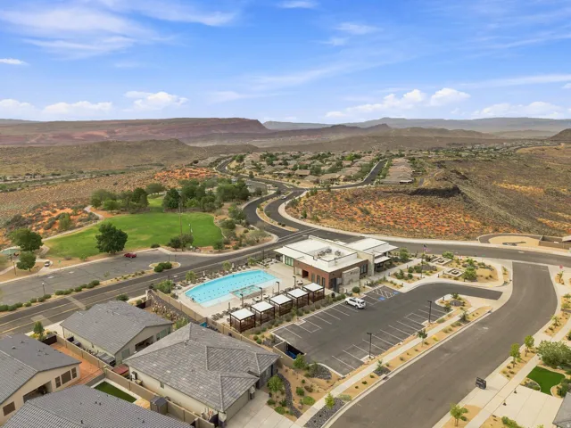 Community amenities featuring a swimming pool with multiple lounge areas, a clubhouse, and a manicured green space