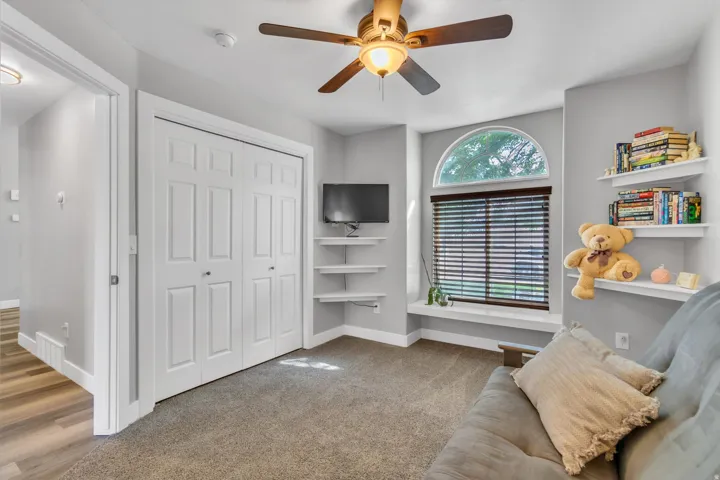 Recessed window with arched transom, integrated window seating, and wood-finish blinds