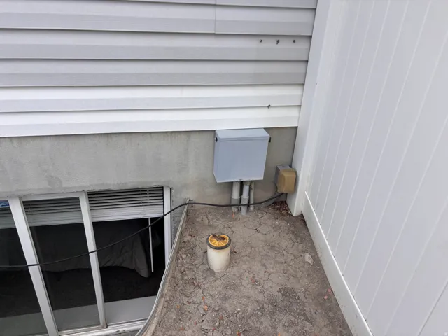 White vinyl siding over a concrete foundation