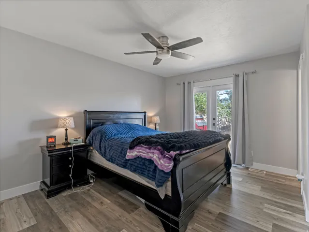 Wood-finish flooring, ceiling fan, and double patio doors