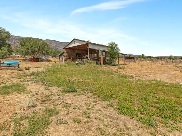 Barn structure featuring a metal roof and open-sided design