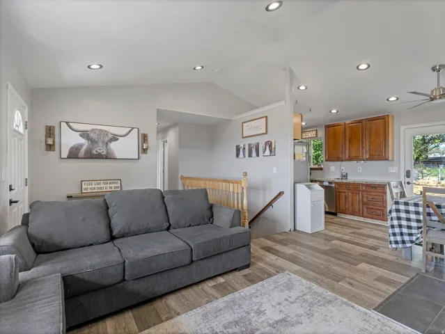 Recessed lighting throughout, wood-finish flooring, light wood cabinetry, stainless steel dishwasher, and a ceiling fan