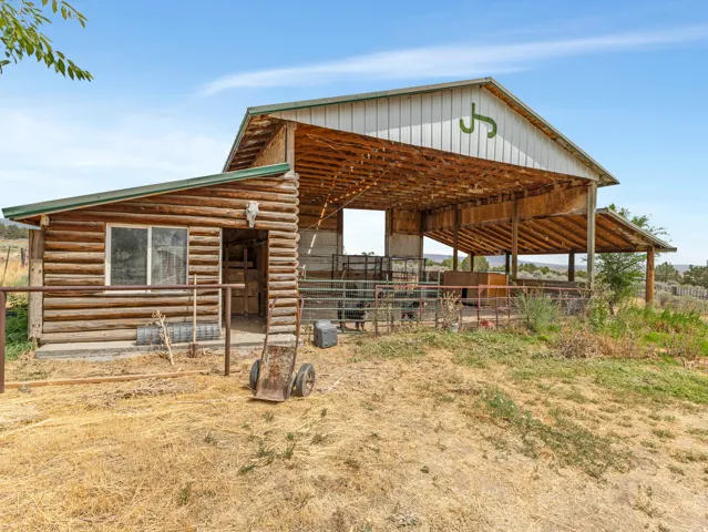 Log cabin-style outbuilding with a metal roof
