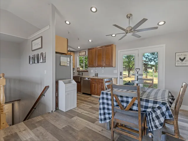 Kitchen and dining area featuring wood-finish flooring, recessed lighting, and a ceiling fan