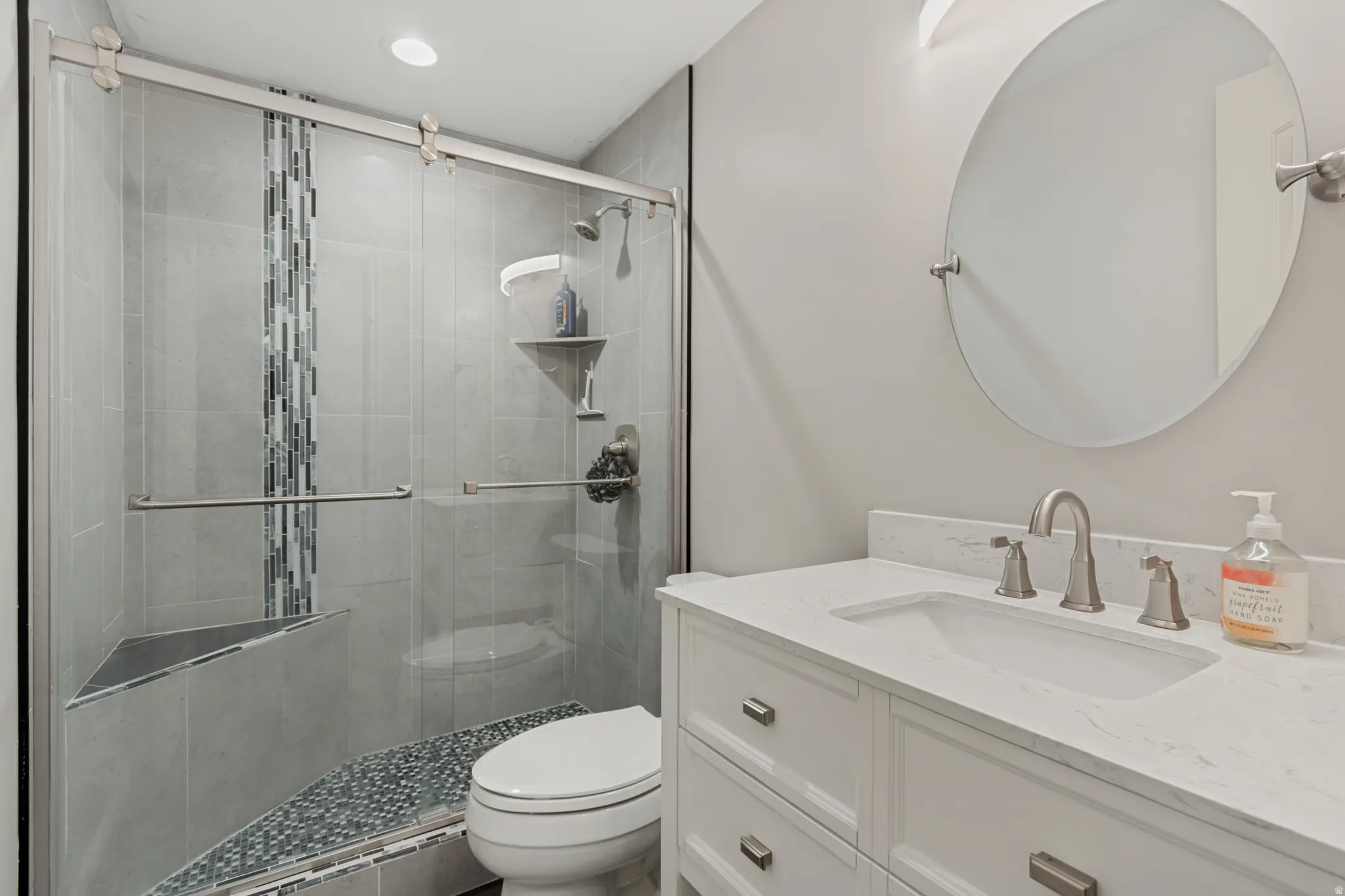 Contemporary bathroom featuring a floating white vanity with dual-sink configuration, quartz countertop, and brushed nickel fixtures