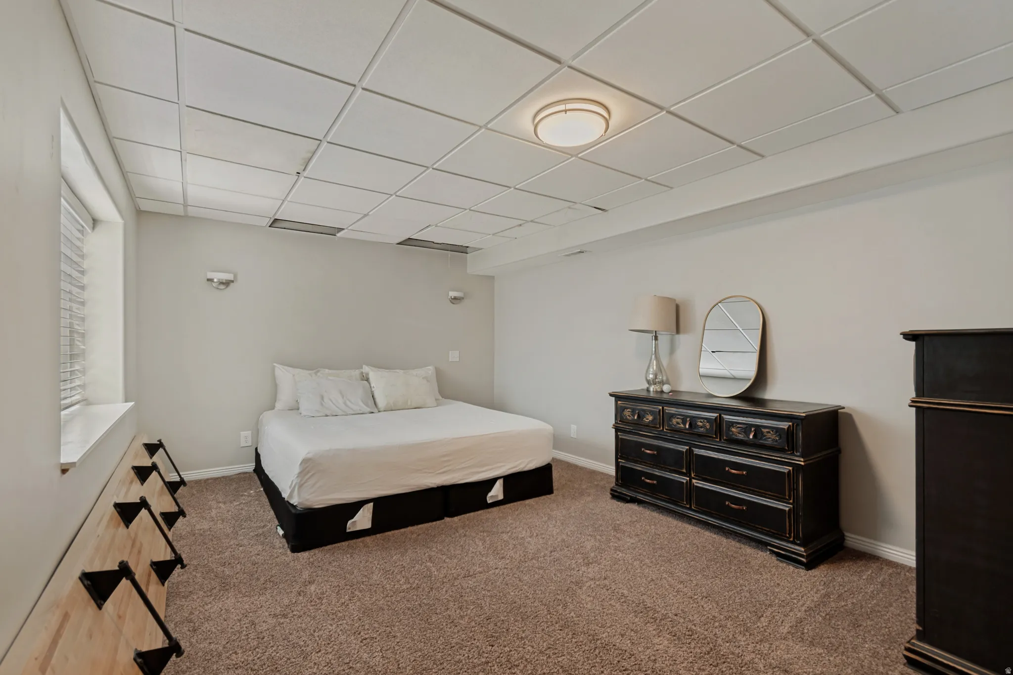 Spacious bedroom with carpeted flooring, recessed ceiling lighting, and ample natural light from large window
