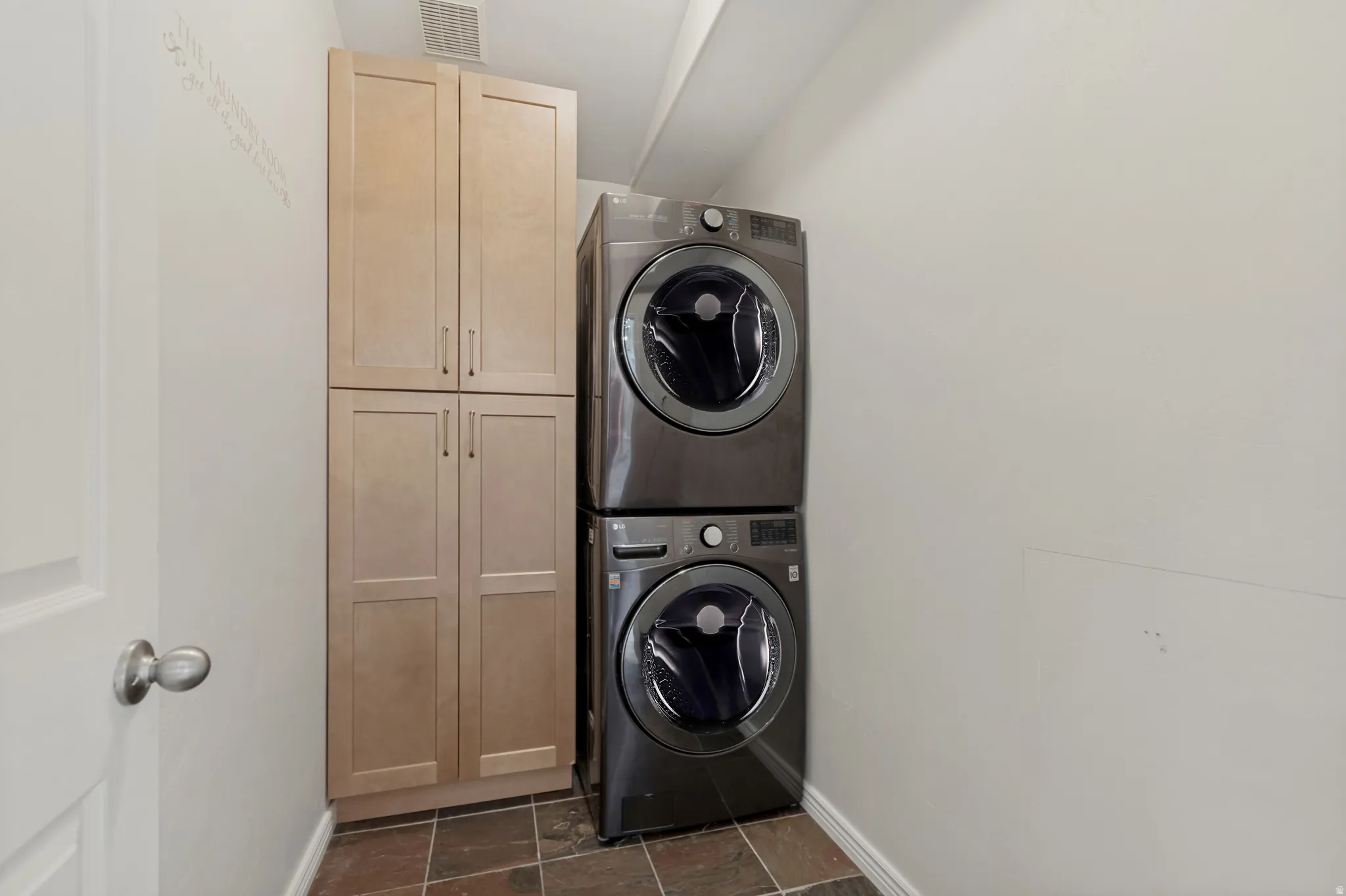 Built-in storage cabinetry, tile flooring, and a white interior door