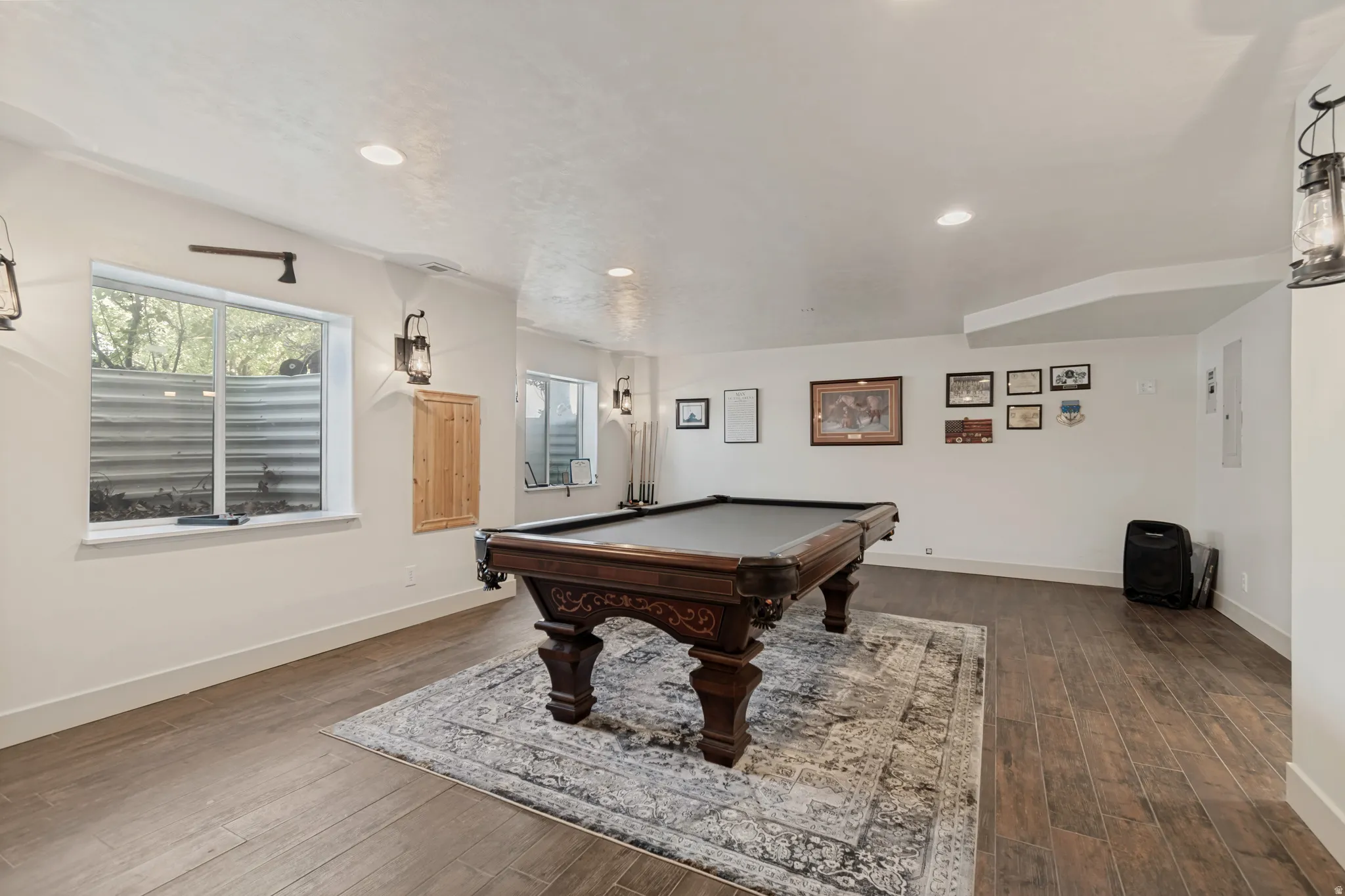 Recessed lighting, wood-finish flooring, and white walls create a bright interior